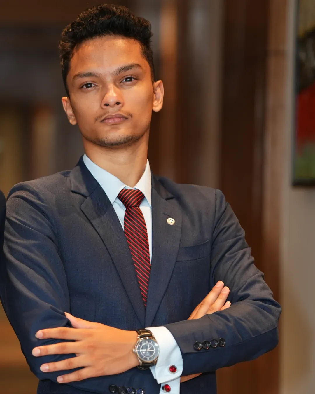 Kovid Panthy facing the camera with his arms folded.