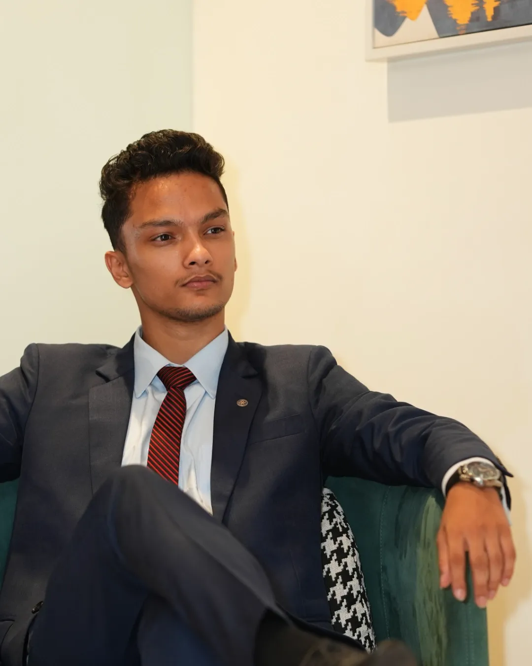 Kovid Panthy seated and turned away from the camera, mid-conversation.