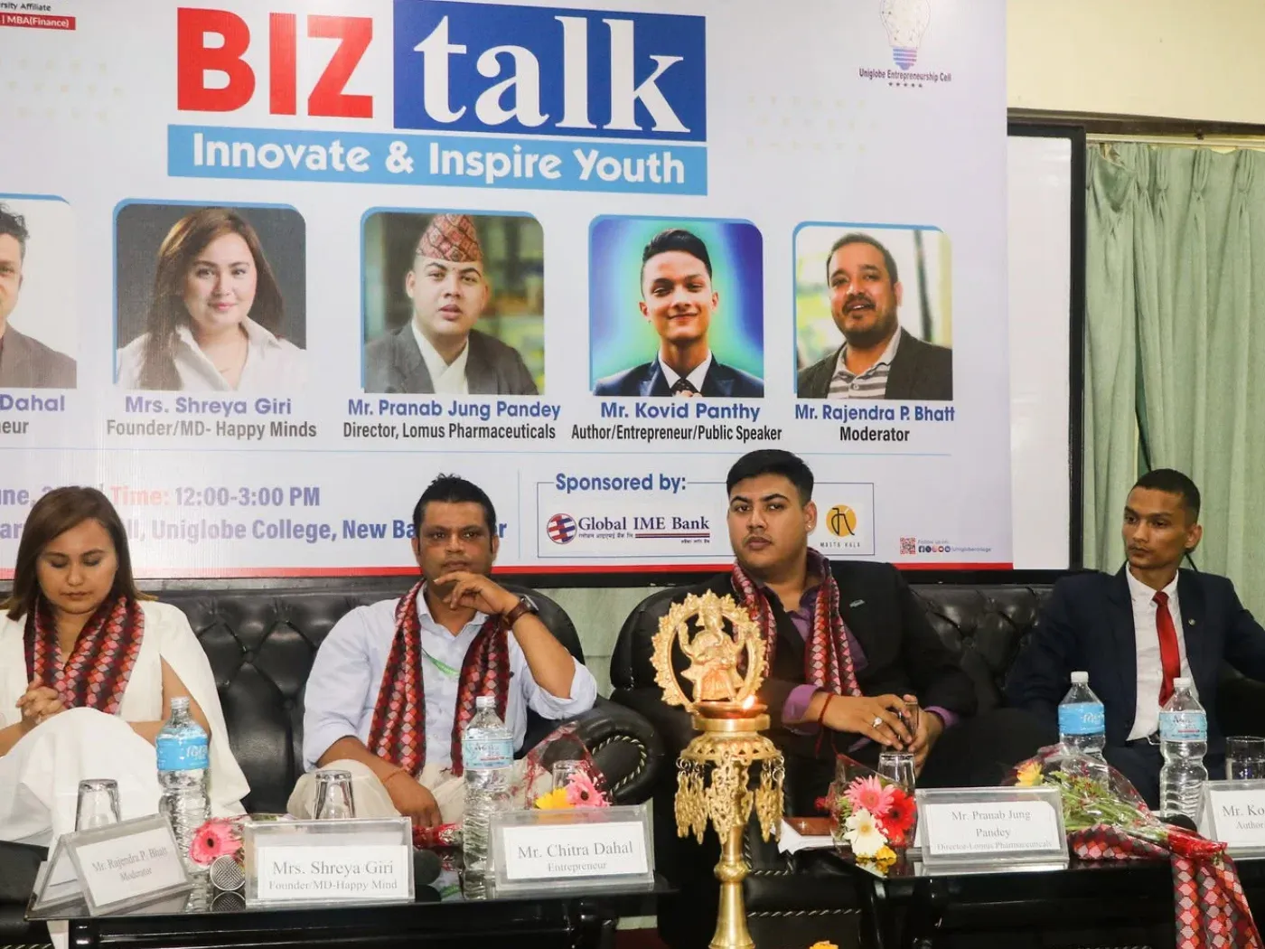 Kovid Panthy on the BizTalk panel at Uniglobe College, listed on the banner behind as Author, Entrepreneur and Public Speaker.